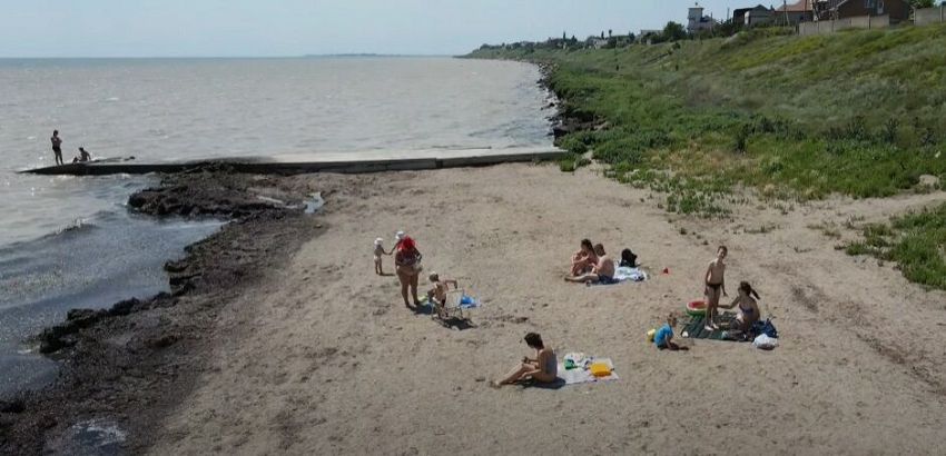 Люди отдыхают на диком пляже.