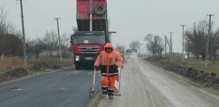 Росіяни під снігом краденою українською технікою «ремонтують» дорогу в Генічеському районі